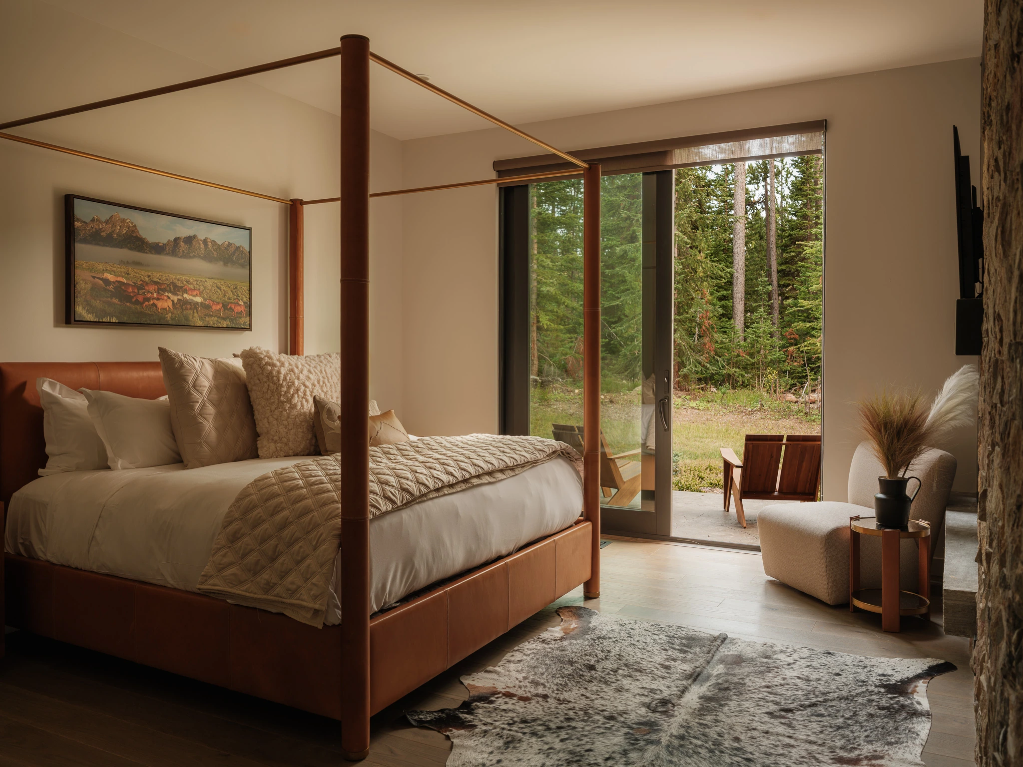 Primary bedroom with sliding glass door onto the pines — interior design photography Big Sky Montana, Reid Smith Architects